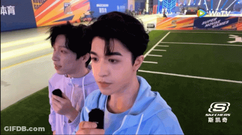 Two Men Standing In Front Of Skechers GIF