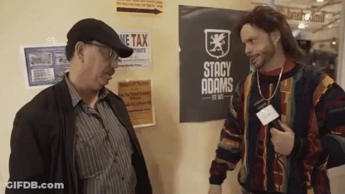 Two Men Standing In Front Of Stacy Adams Sign GIF