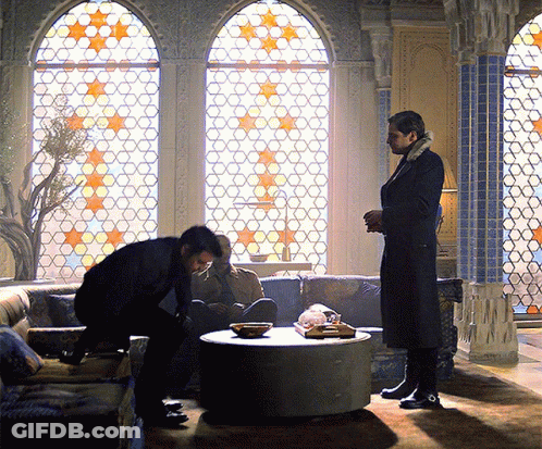 Two Men Standing In Front Of Stained Glass Window GIF