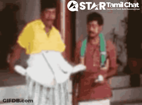 Two Men Standing In Front Of Star Tamil Chat Ad GIF
