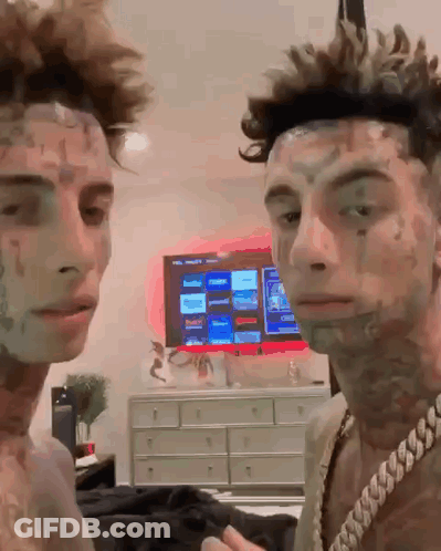 Two Men Standing In Front Of Television GIF