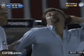 Two Men Standing In Front Of TV Publica GIF