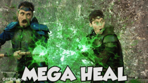 Two Men Standing In Front Of Wall Saying Mega Heal GIF