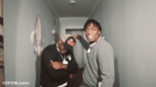 Two Men Standing In Hallway Making Funny Faces GIF