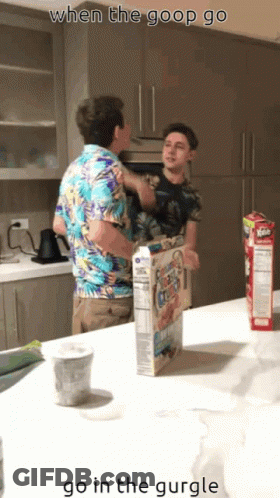 Two Men Standing In Kitchen With Cereal Box GIF