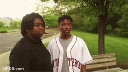 Two Men Standing In Park GIF