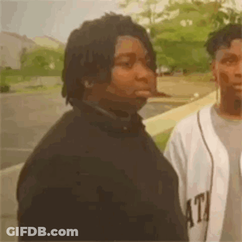 Two Men Standing In Parking Lot GIF