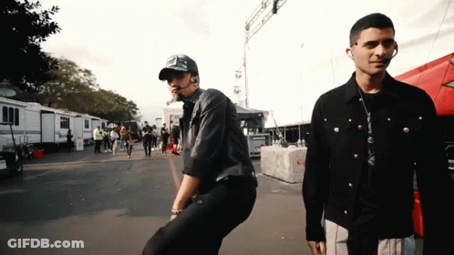 Two Men Standing In Parking Lot GIF