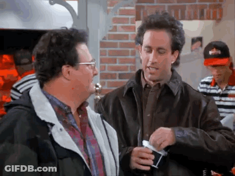 Two Men Standing In Restaurant Talking GIF