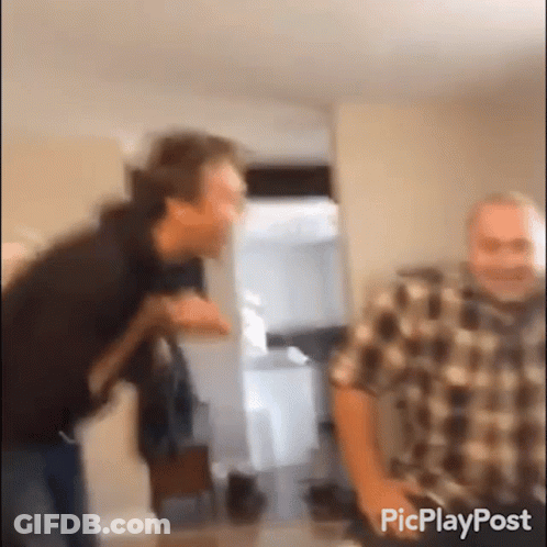 Two Men Standing In Room GIF