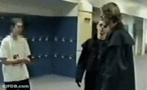 Two Men Standing In School Hallway GIF