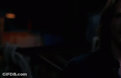 Two Men Standing In The Dark GIF