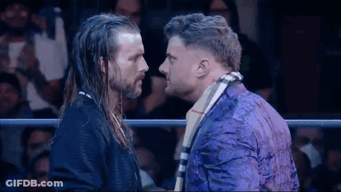 Two Men Standing In Wrestling Ring GIF