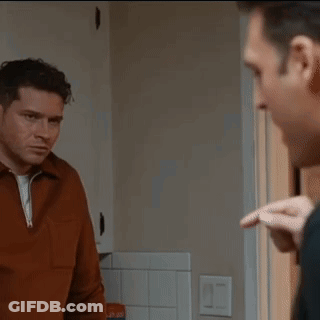 Two Men Standing Looking At Each Other GIF