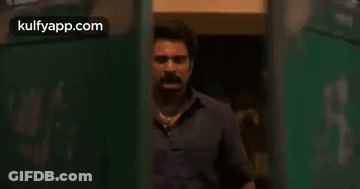 Two Men Standing Near Door GIF
