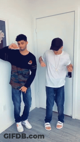 Two Men Standing Near Door With Fila Sandals GIF