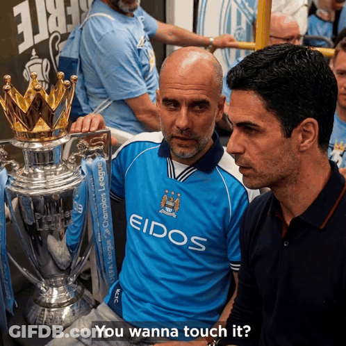Two Men Standing Next To A Trophy With The Words " You Wanna Touch It " Below Them GIF