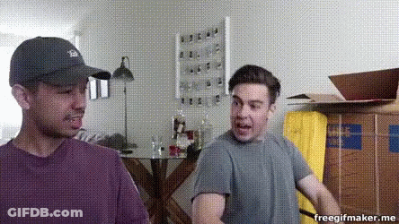 Two Men Standing Next To Boxes GIF