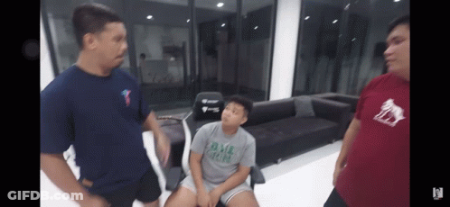Two Men Standing Next To Boy In DMZ Crew Shirt GIF