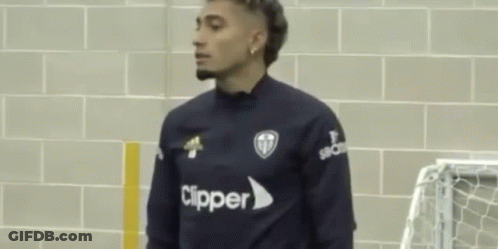 Two Men Standing Next To Brick Wall GIF