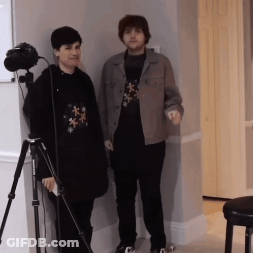 Two Men Standing Next To Camera GIF