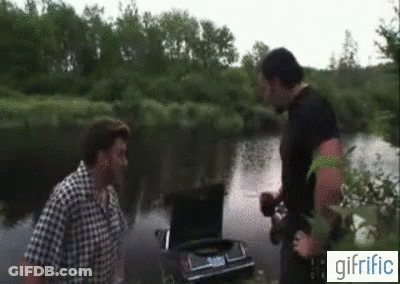 Two Men Standing Next To Car In River With Trunk Open GIF