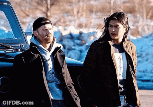 Two Men Standing Next To Car In Snow GIF