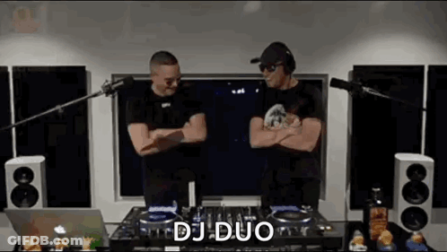 Two Men Standing Next To DJ Mixer GIF