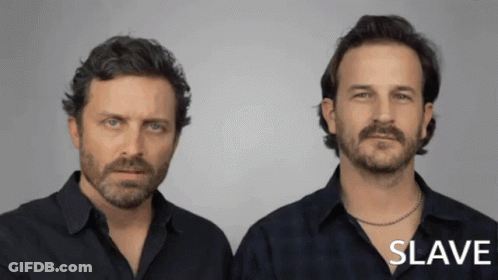 Two Men Standing Next To Each Other GIF