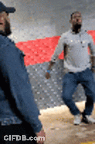Two Men Standing Next To Each Other GIF