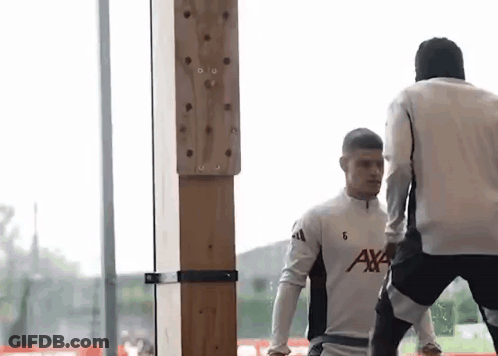Two Men Standing Next To Each Other GIF