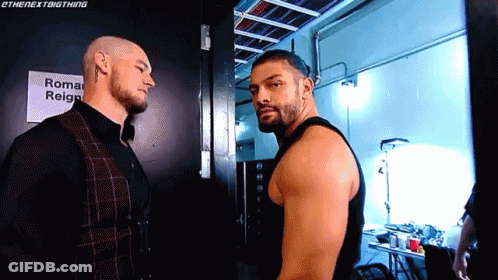 Two Men Standing Next To Each Other GIF