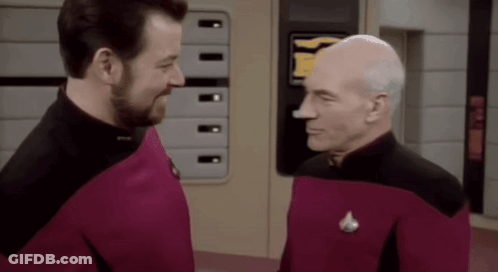 Two Men Standing Next To Each Other GIF