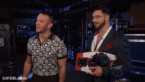 Two Men Standing Next To Each Other GIF