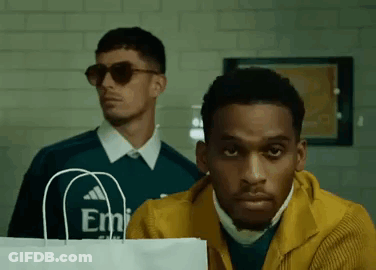 Two Men Standing Next To Each Other GIF