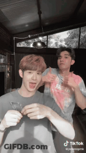 Two Men Standing Next To Each Other GIF
