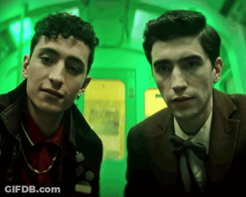 Two Men Standing Next To Each Other Green Background GIF