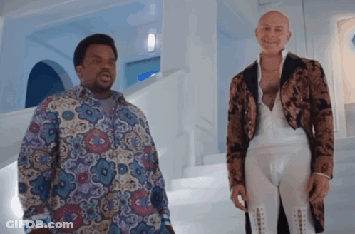 Two Men Standing Next To Each Other In A Room GIF