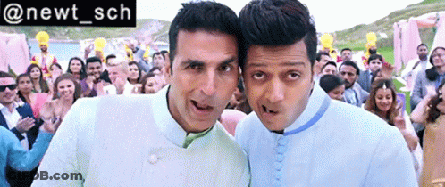 Two Men Standing Next To Each Other In Front Of A Crowd With The Hashtag @Newt_sch On The Bottom GIF