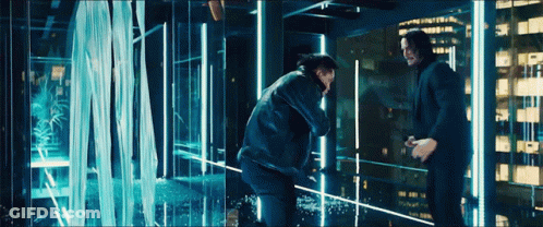 Two Men Standing Next To Each Other In Front Of A Waterfall . GIF