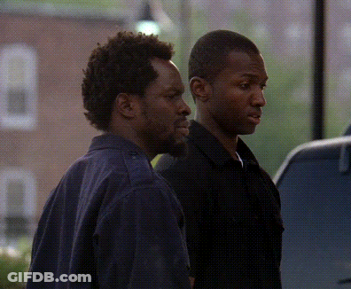Two Men Standing Next To Each Other In Front Of Window GIF