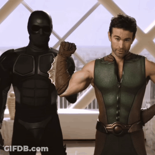 Two Men Standing Next To Each Other In Front Of Window GIF
