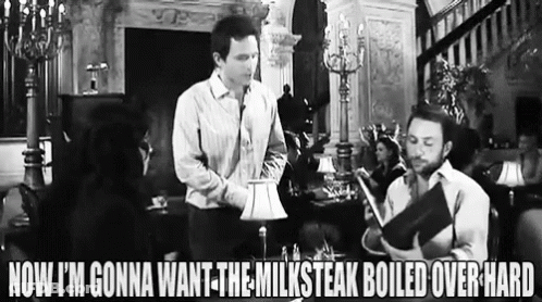Two Men Standing Next To Each Other In Living Room GIF