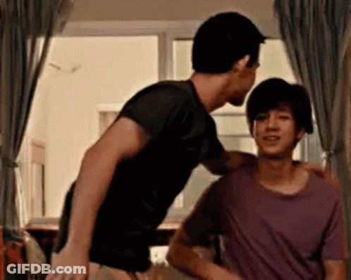 Two Men Standing Next To Each Other In Room GIF