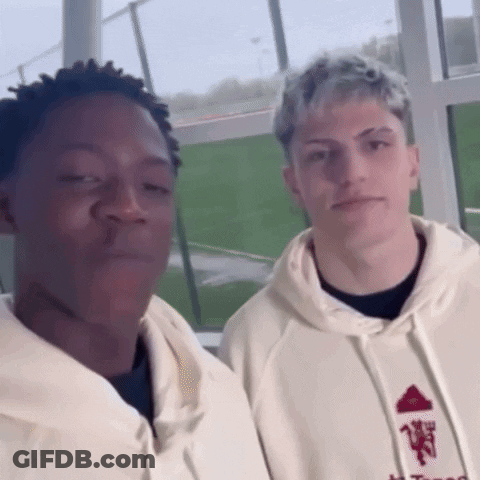 Two Men Standing Next To Each Other GIF