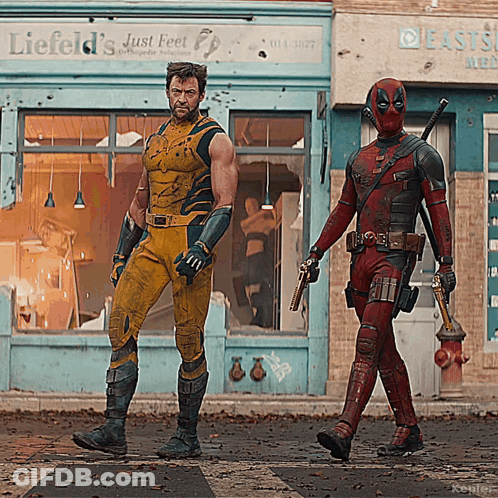 Two Men Standing Next To Each Other On Stage GIF