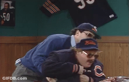 Two Men Standing Next To Each Other One In Bear Jacket GIF