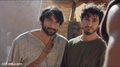 Two Men Standing Next To Each Other One In Gray Shirt GIF