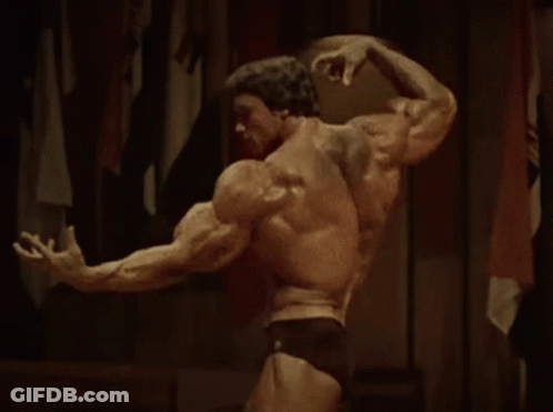 Two Men Standing Next To Each Other One In Red Shirt GIF