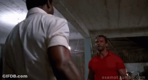 Two Men Standing Next To Each Other One In Red Shirt GIF